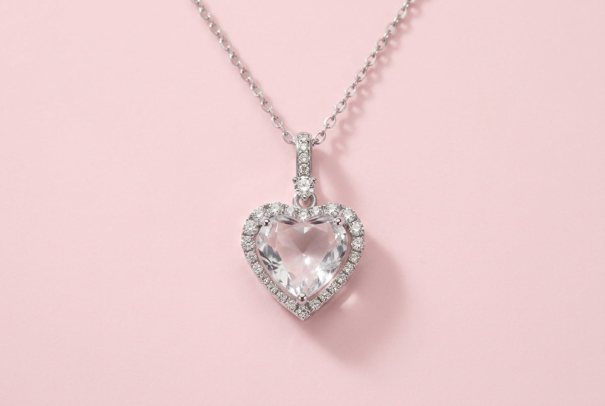 Sterling silver heart pendant necklace with brilliant moissanite center stone and halo setting on delicate chain