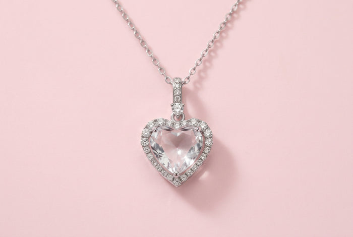 Sterling silver heart pendant necklace with brilliant moissanite center stone and halo setting on delicate chain